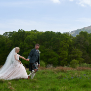 couple walking through long grass